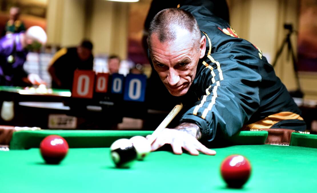 CONCENTRATION: Tasmanian masters team member Wayne Stubbs lines up a shot at the Australian Eightball Championships. Picture: Neil Richardson