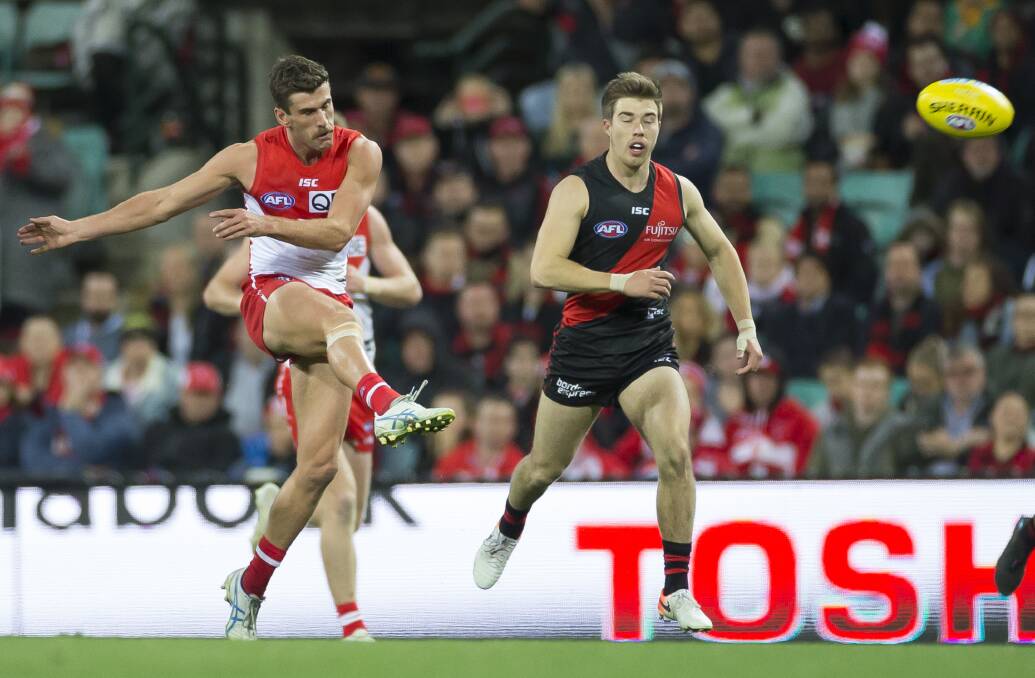  BANG: Burnie's Robbie Fox bangs the ball forward during Sydney's thrilling win over Essendon on Friday. Picture: AAP Image/Craig Golding