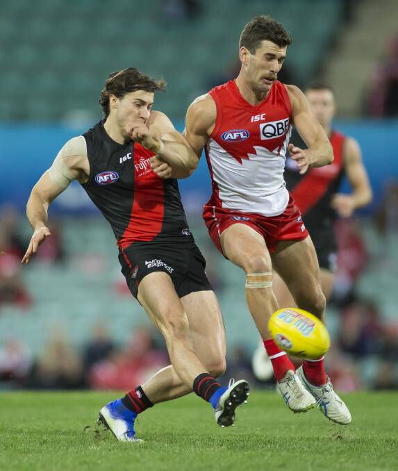 CONTEST: Robbie Fox battles it out with Andrew McGrath on Friday. Picture: AAP Image/Craig Golding