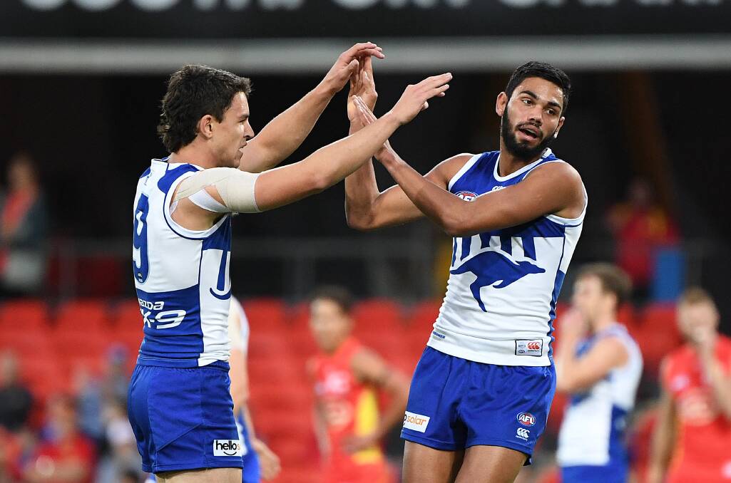 HIGH FIVE: Tarryn Thomas celebrates a goal against Gold Coast on Saturday on his way to a Rising Star nomination. Picture: AAP Image/Dave Hunt