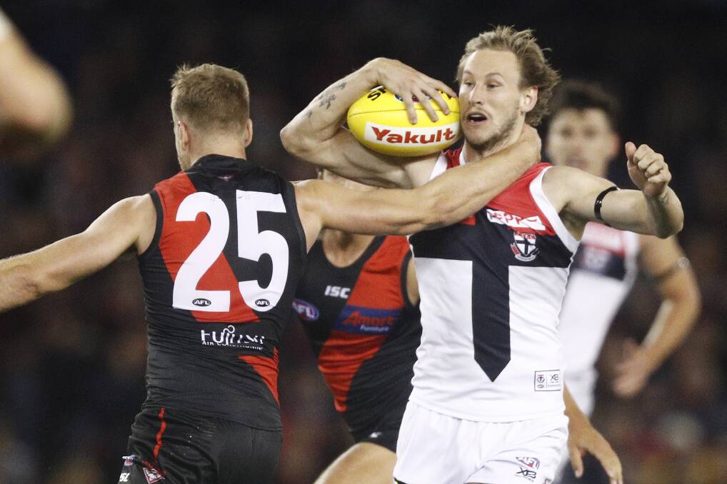 Jimmy Webster gets some attention from Essendon's Jake Stringer on Saturday. Picture: AAP Image/Daniel Pockett