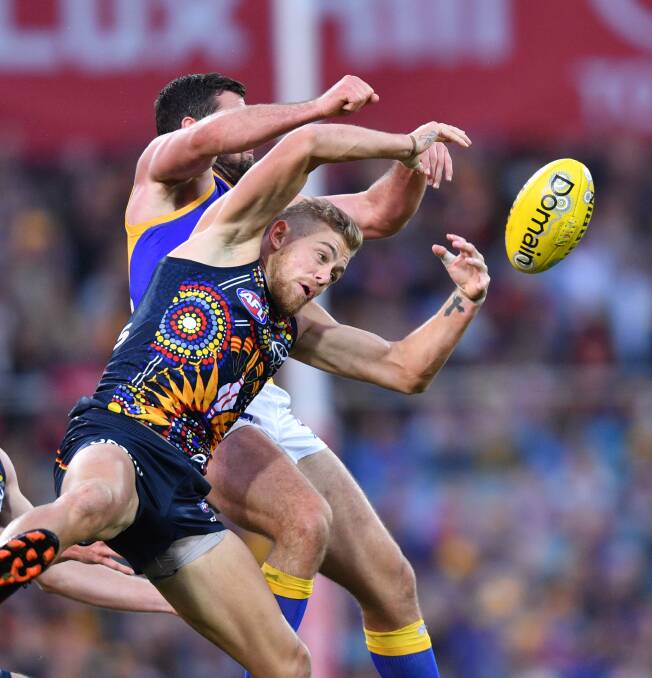 ROUGH AND TUMBLE: Hugh Greenwood contests the ball in Adelaide's loss to West Coast on Saturday at Adelaide Oval. Picture: AAP Image/David Mariuz