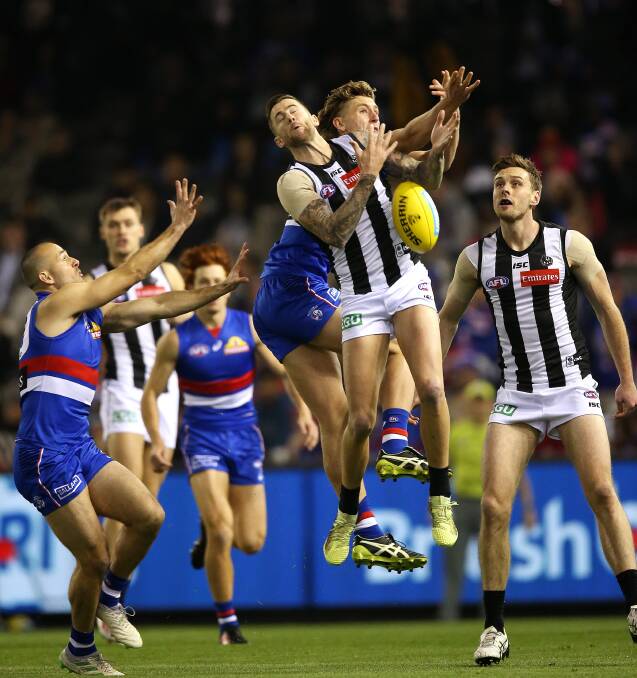 CRUNCH: Jeremy Howe receives some heavy contact against the Western Bulldogs on Sunday. Picture: Wayne Ludbey 