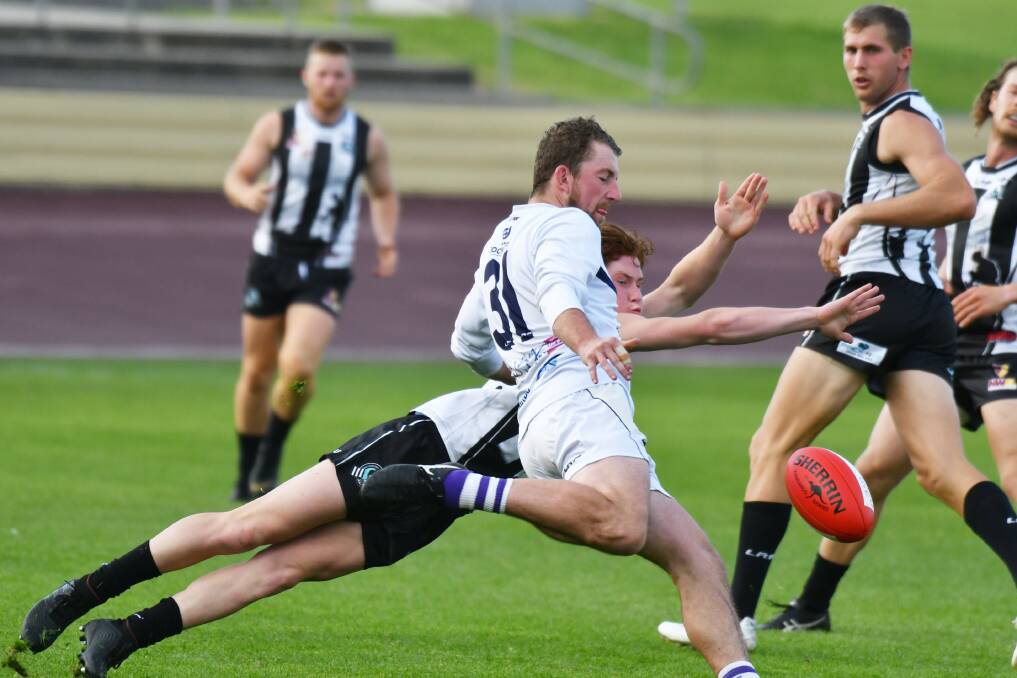 Burnie's Brodie Knight gets his kick away during the NWFL match between Devonport and Burnie. Picture: Brodie Weeding.