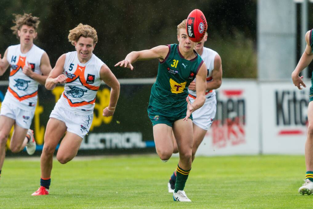 AFTER IT: Tasmania Devils' Ryley Sanders on the run during the Devils outing at Windsor Park against Calder Cannons in April. Picture: Phillip Biggs 