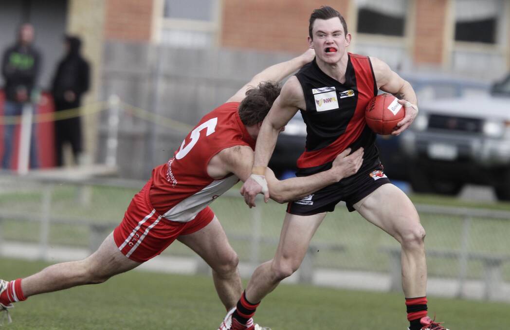 NO WAY: Ulverstone's Jack Dilger shrugs off East Devonport's Nathan Applebee on Saturday. Picture: Brodie Weeding.