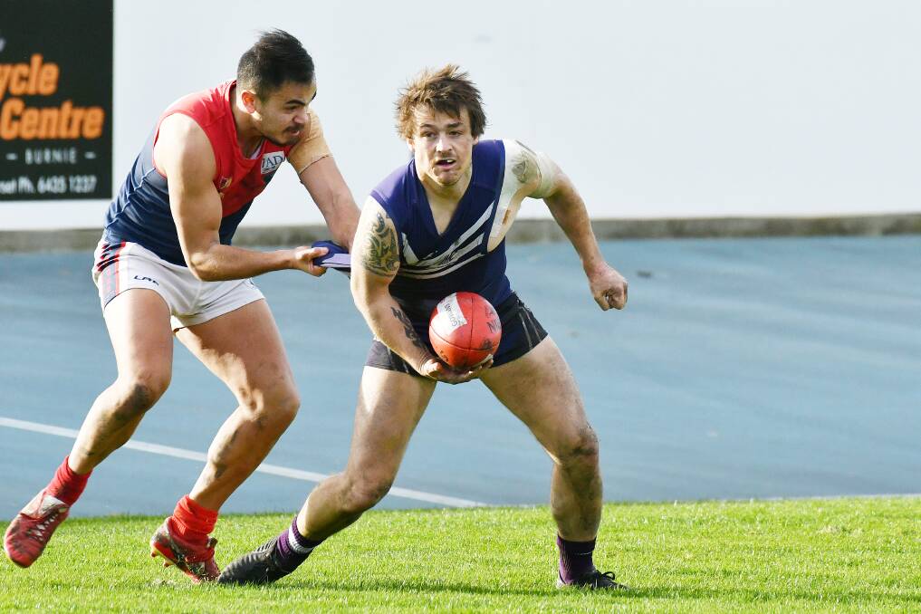 PRESSURE: Burnie's Lucas Ford battles to hold onto the ball during the NWFL clash between Burnie and Latrobe. Picture: Brodie Weeding.