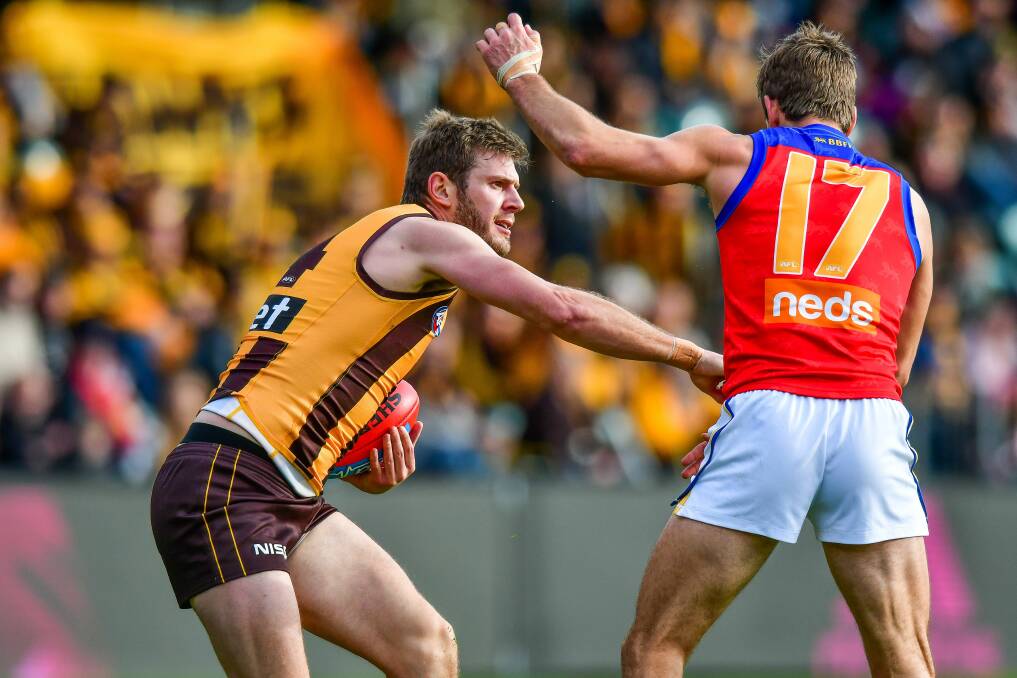 GET OUT OF MY WAY: Grant Birchall sends a message to Jarryd Lyons in Saturday's AFL outing in Launceston, which was his second match for the season. 