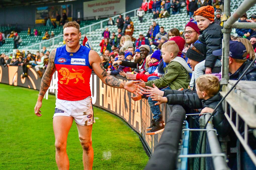 HIGH FIVE: Mitch Robinson celebrates with the UTAS Stadium crowd after Brisbane's win over Hawthorn on Saturday. Pictures: Scott Gelston