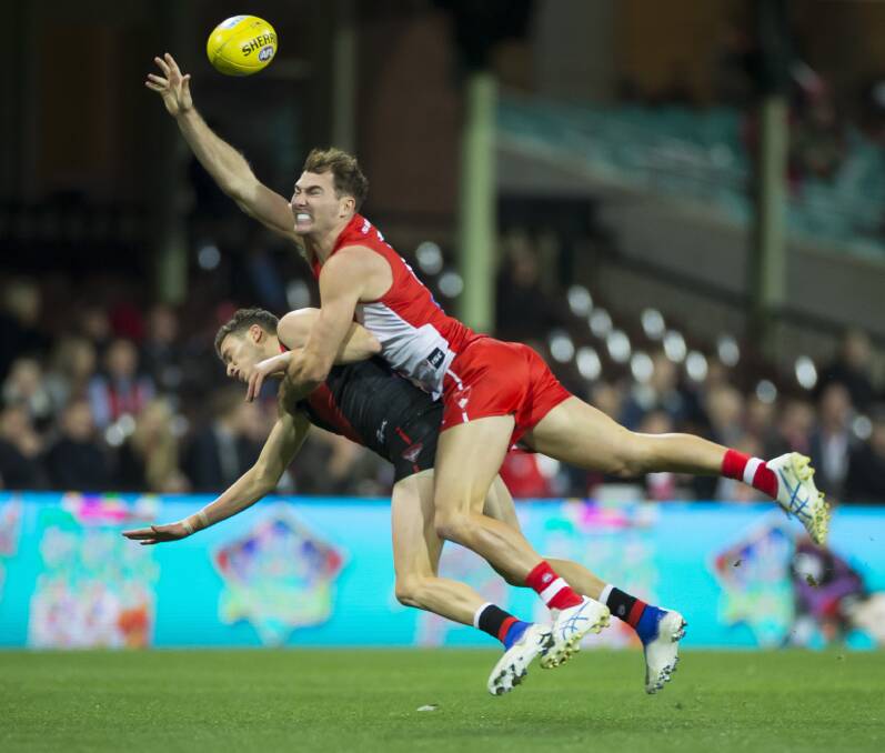 STRONG REACH: Jackson Thurlow of the Swans competes with Orazio Fantasia on Friday night in Sydney. Picture: AAP Image/Craig Golding
