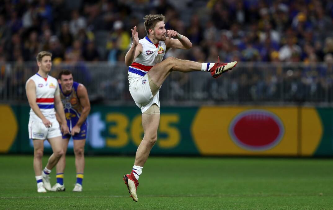 FIRST BITE: Ryan Gardner kicks for goal during his AFL debut in the Western Bulldogs' loss to West Coast on Sunday. Picture: AAP Image/Gary Day