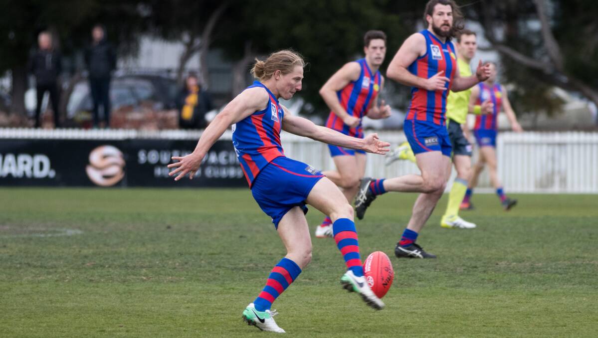 BANG: Eli Templeton bangs the ball forward for Port Melbourne this season. He and fellow former Burnie Docker Brody Mihocek are chasing a VFL flag on Sunday. Picture: Mozzed Video And Photography