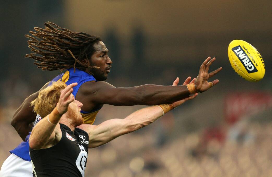 Andrew Phillips competes in the ruck against Nic Naitanui. Picture: AAP Image/Hamish Blair