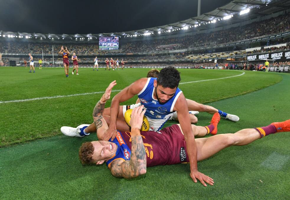 TASSIE TUSSLE Tarryn Thomas and Mitch Robinson get to know each other during Brisbane's win over North Melbourne at the Gabba. Picture: AAP Image Darren England 