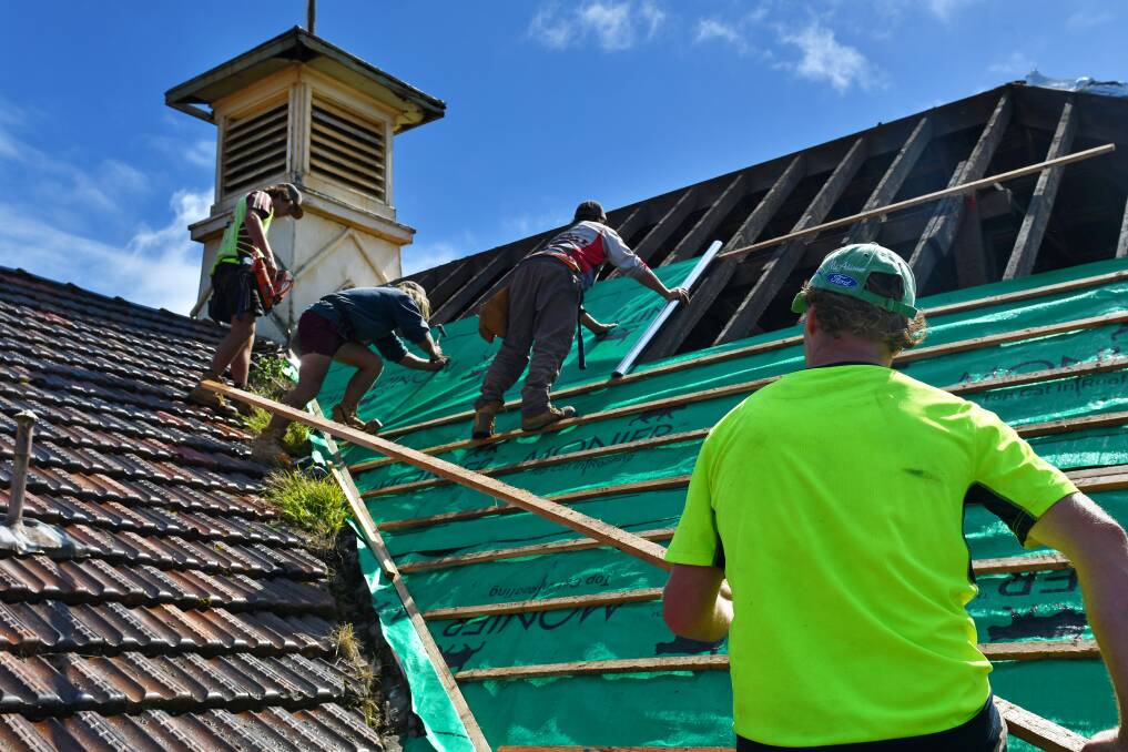 Good on paper: Roof tiling restoration at the old paper mill in Burnie. Picture: Brodie Weeding