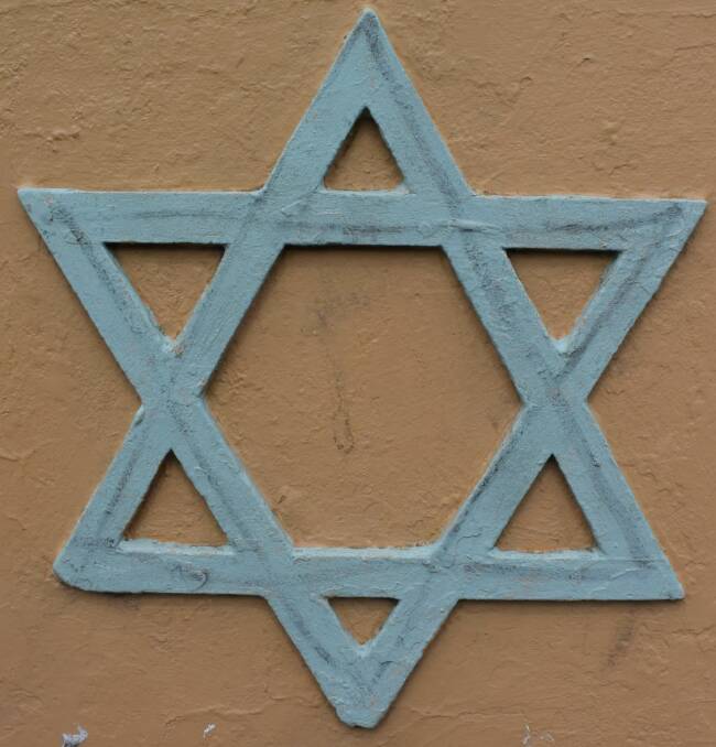 A black line has been drawn through the Star of David hanging outside Launceston's synagogue. 