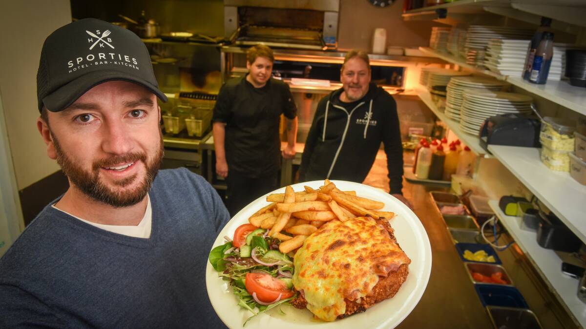 STAYING CLOSED: Sporties Hotel owner Nick Daking said the hotel will stick to offering takeaway parmi's until they can open again at close to 100 per cent capactiy, with head chef Prue Foden and manager Geoff Lindsay. Picture: Paul Scambler.