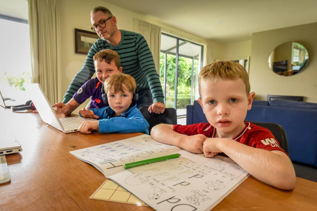 HOME SCHOOL: Bede Clifton and his three sons who attend Scotch Oakburn College in a makeshift classroom at home. Picture: Paul Scambler