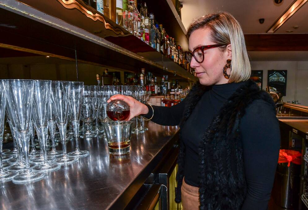 STRAIGHT: Country Club Bar supervisor Georgia Thomas pouring a glass of whiskey ahead of Whiskey Week's showcase on Friday. Picture: Neil Richardson