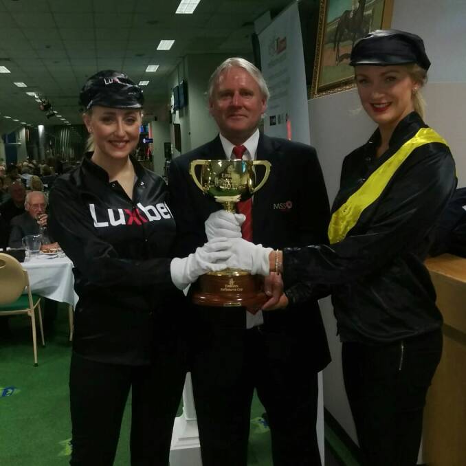 PROUD: Anthony Cook with a two promotional workers while working with the Melbourne Cup. Picture: Supplied