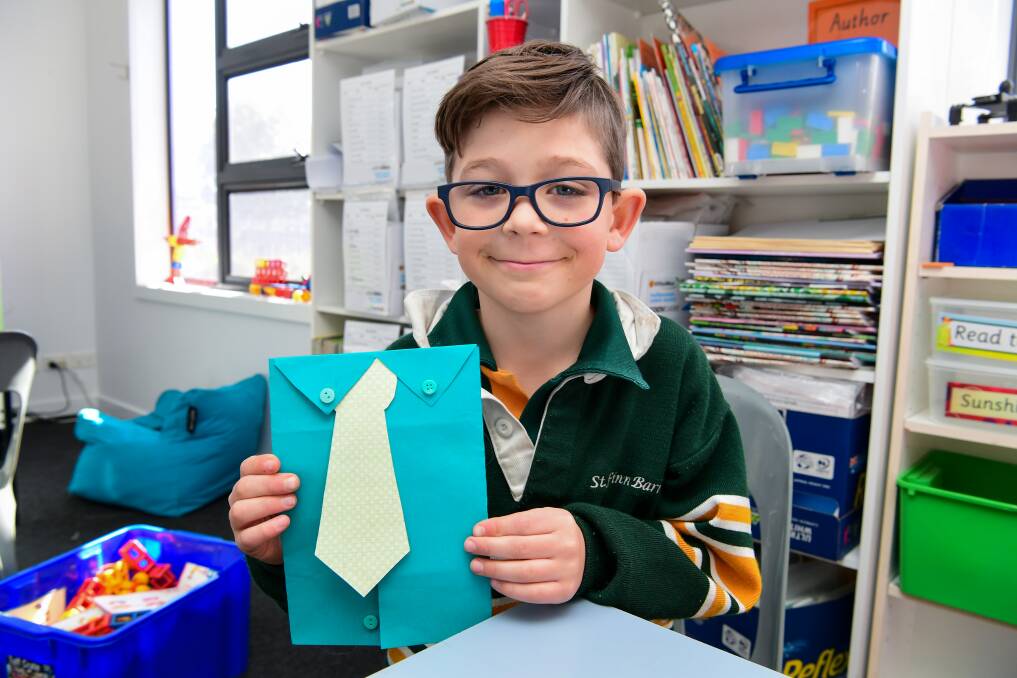 Oscar Alexander with the card he made for his father. Picture: Neil Richardson