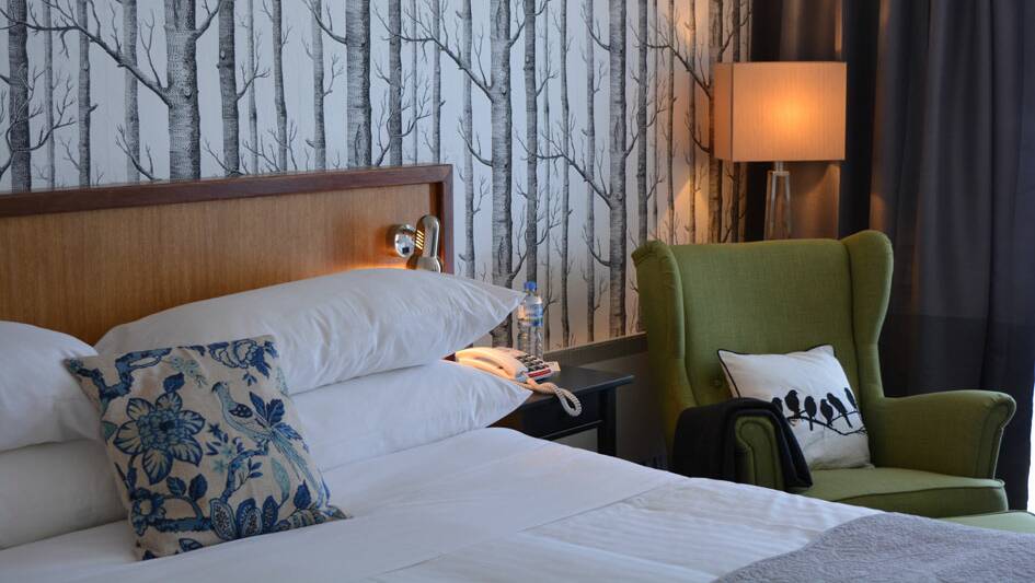 A Deluxe Room at The Waterfront Wynyard includes a king bed.