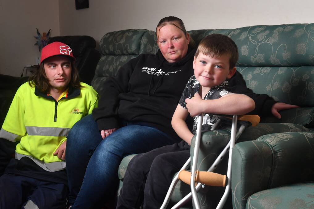 NOT IMPRESSED: Six-year-old Axel Fielding with his parents Alex and Kristy Fielding. Picture: Brodie Weeding 