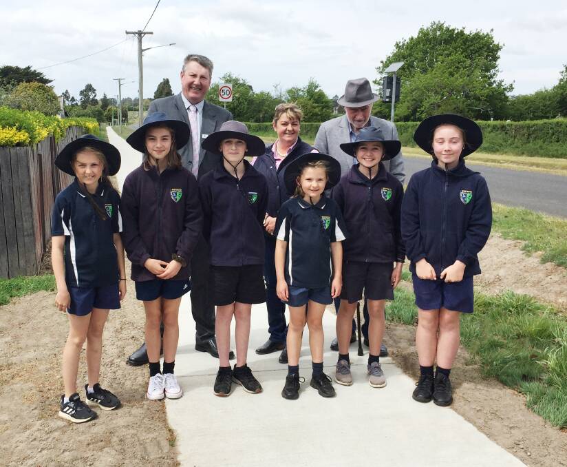 STEP IN THE RIGHT DIRECTION: Mayor Wayne Johnston, councillor Tanya King and councillor Frank Nott with students from Westbury Primary as they test out the new footpath on Dexter Street. Picture supplied.