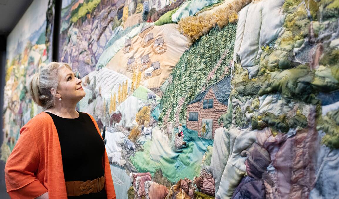 RECOGNITION: Great Western Tiers Visitor Centre employee Julie Self with the Yarns Artwork in Silk. Picture: Supplied