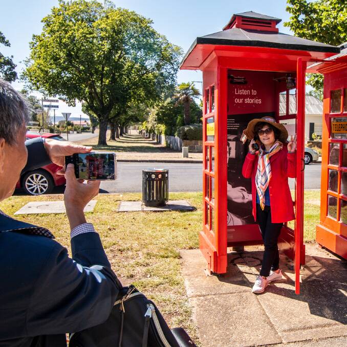 FULL OF AWARDS: Tourists check out Ross's Dial A Local phone box, which was recognised as a creative project by the Tasmanian Keep Australia Beautiful judges. Picture supplied.
