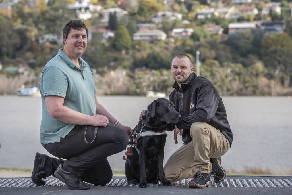 AWARENESS: Handler Rob Whyte, guide dog Mr J and Guide Dog Tasmania's Sean Cromwell. Picture: Craig George