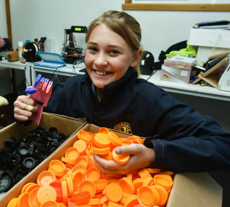 INNOVATION: Evandale Primary School pupil Taryn Farrell with some bottle caps and lids that have been donated to make prosthetic hands for children in developing countries. Picture: Neil Richardson. 