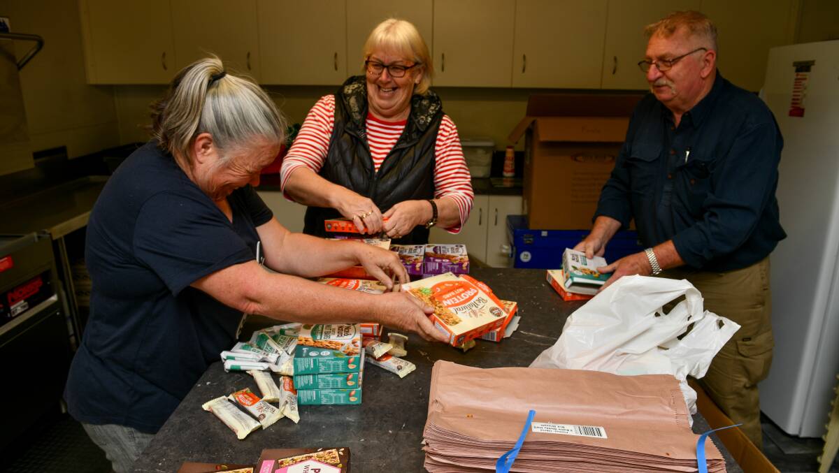 VOLUNTEERS: Karen Bird, Christine Chilcott and Brian MGowan prepare lunches for the Fly Fishing World Championships at the Meander Hall. Picture: Scott Gelston.