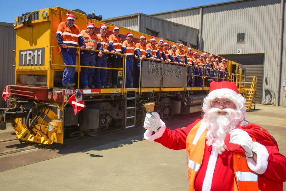 HO HO HO: Santa with TasRail workers on the Christmas train in 2017. Pictures: Paul Scambler.
