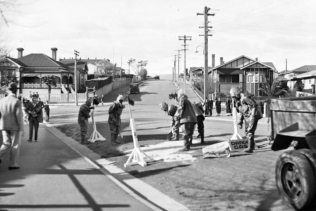 HOMEFRONT: The corner of Mary Street and Abbott Street, Launceston, showing Civil Defence personnel wearing gas masks and other protective equipment as they participate in a rehearsal exercise on August 24, 1940. Picture: QVMAG collection.