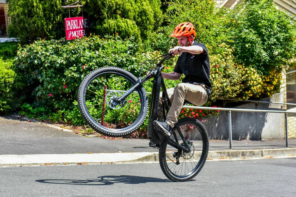 WHEELIE: Roll Cycles store manager Darren Singline shows the ability of the Specialized Levo electric bike on the Weymouth Street hill. Picture: Neil Richardson.