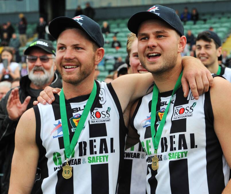 WINNERS: Glenorchy's Josh Arnold and Daniel Muir grin as they watch the premiership celebrations get under way.