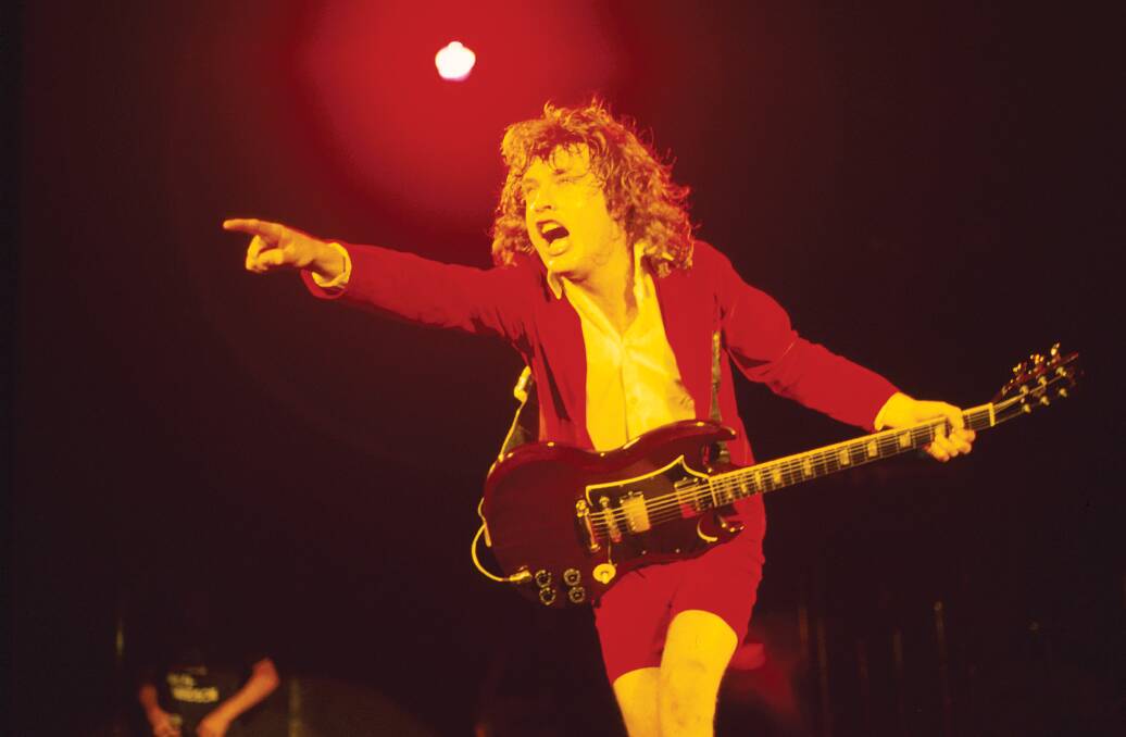 King of the Concert: AC/DC's Angus Young takes control of his Gibson SG guitar in 1981 on the Back in Black tour. Pictures: Bob King