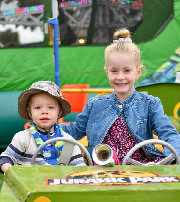 Riding high: Liam, 1, and Ella Grubert, 6, take a spin on one of the sideshow rides at Chilli Skyfire. Picture: Scott Gelston