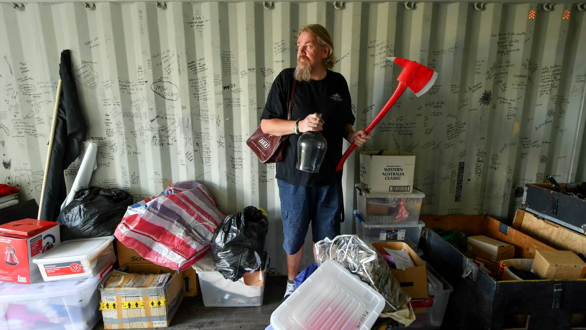 Looking Back: Three River Theatre's Cameron Hindrum with some props from the company's archives at their new storage facility, Bek's Room, in Mowbray. Picture: Scott Gelston.