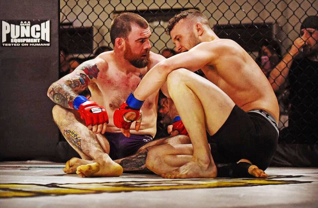 Ben Barrett and Jordan Wallace sit on the canvas after their Valor MMA bout. Picture: Scott Gelston