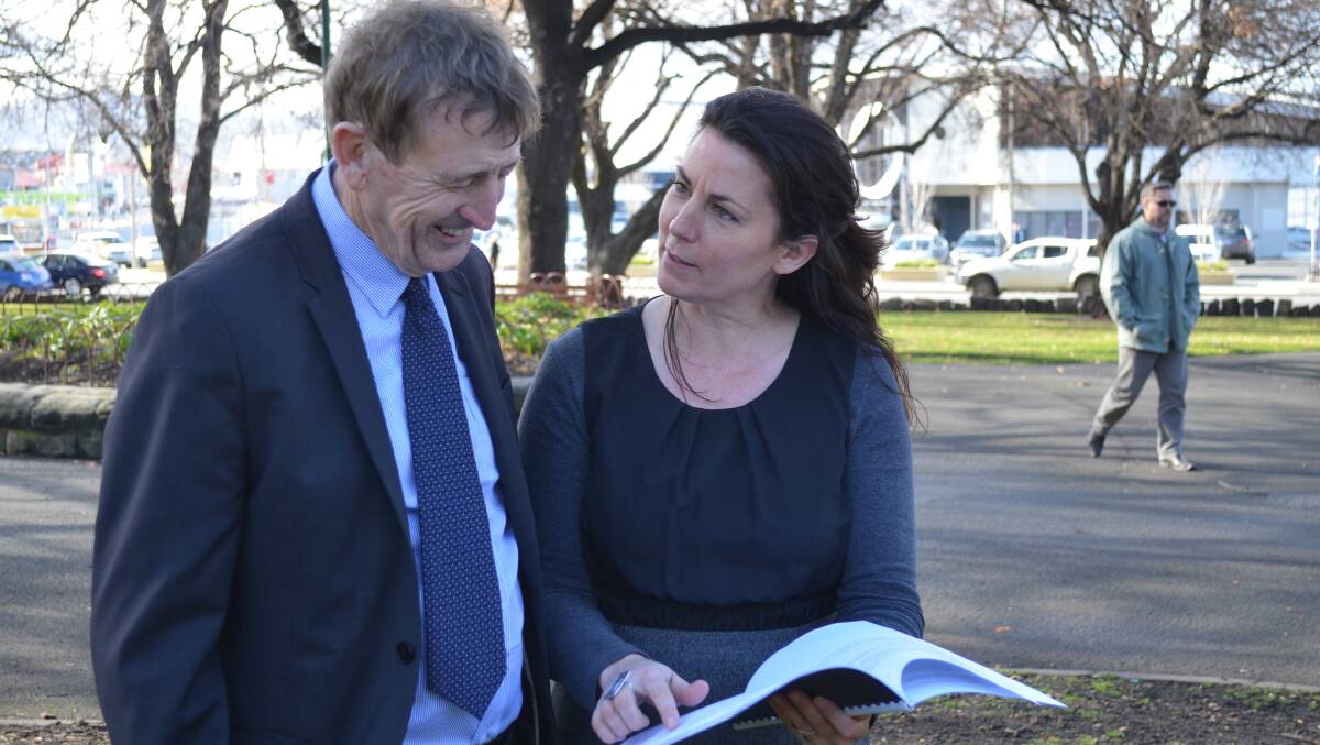 Australian Institute for Business and Economics director John Mangan and Anglicare Social Action and Research Centre manager Meg Webb review a report on a pokies ban.