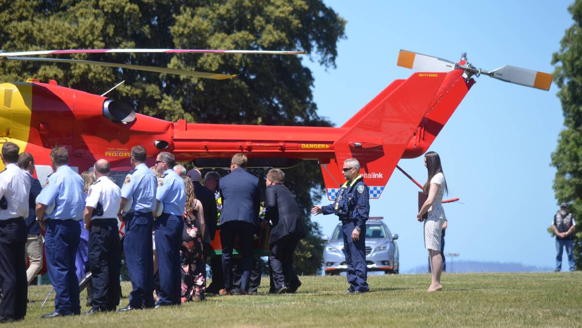 Air rescue pilot Roger Corbin's casket is loaded into a helicopter at a funeral service in Hobart on Tuesday. Picture: Matt Maloney