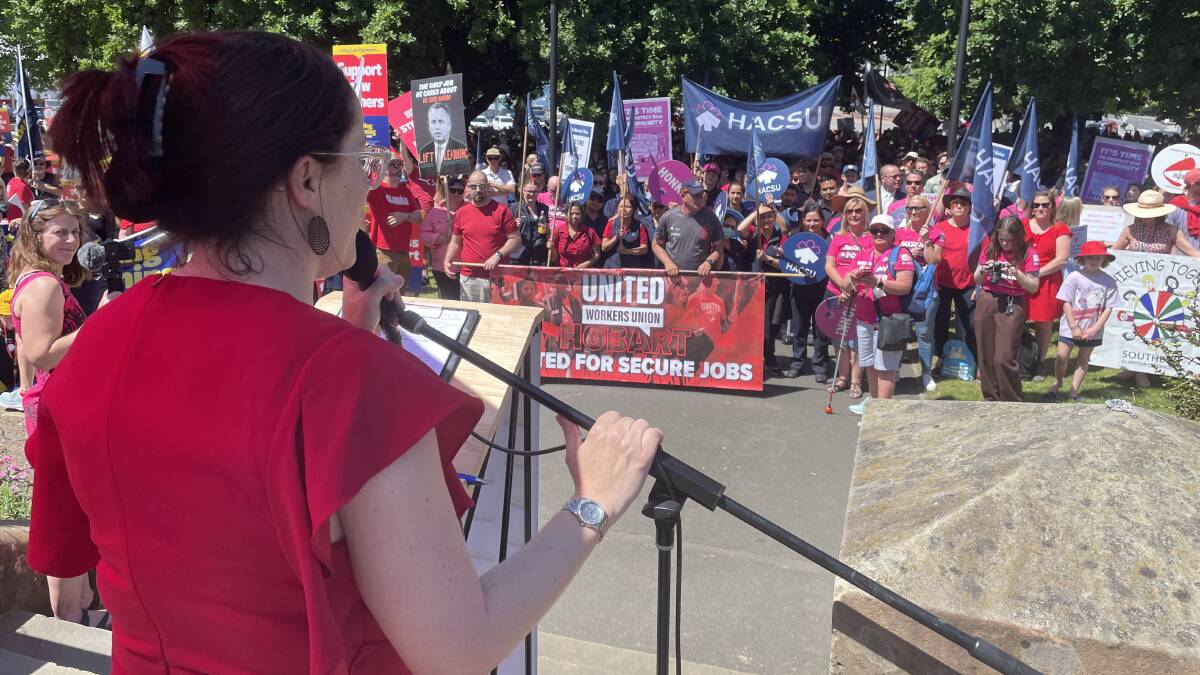 Unions Tasmania secretary Jessica Munday addresses thousands of public sector workers gathered outside Parliament House on Wednesday.