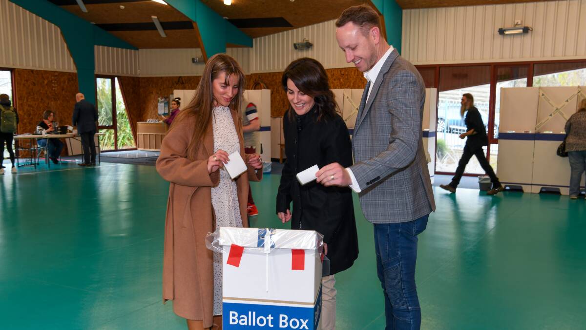 Rosevears Liberal candidate Jo Palmer submits her vote in West Launceston on Saturday with husband Andrew Palmer and daugher Lily Cornish.