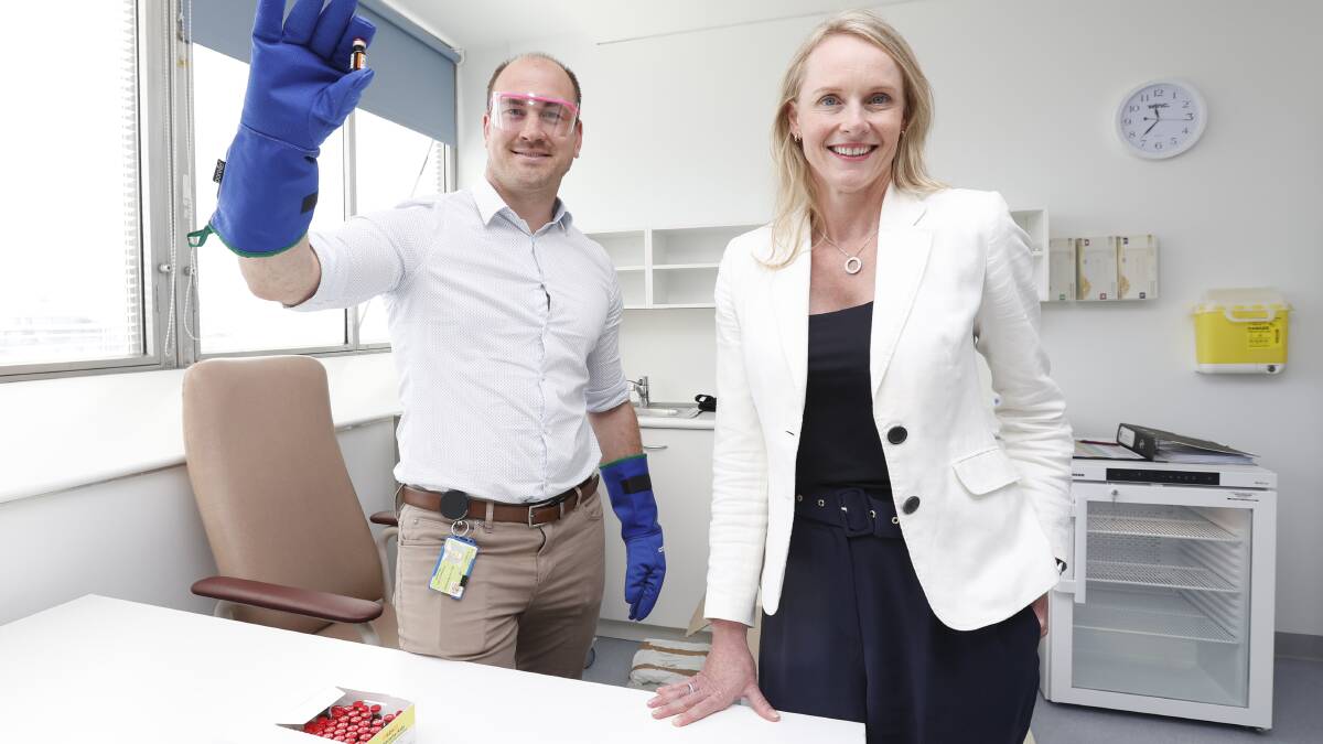 Southern pharmacy site manager Duncan McKenzie with Health Minister Sarah Courtney with a mock vile of a vaccine used for rehearsals. Picture: supplied