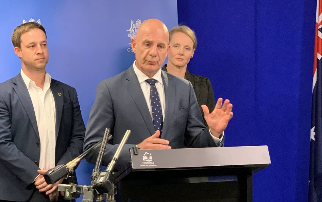 Premier Peter Gutwein announces details of an economic stimulus package for Tasmania will be announced next week, flanked by Master Builders Tasmania chief executive Matthew Pollock and Health Minister Sarah Courtney.