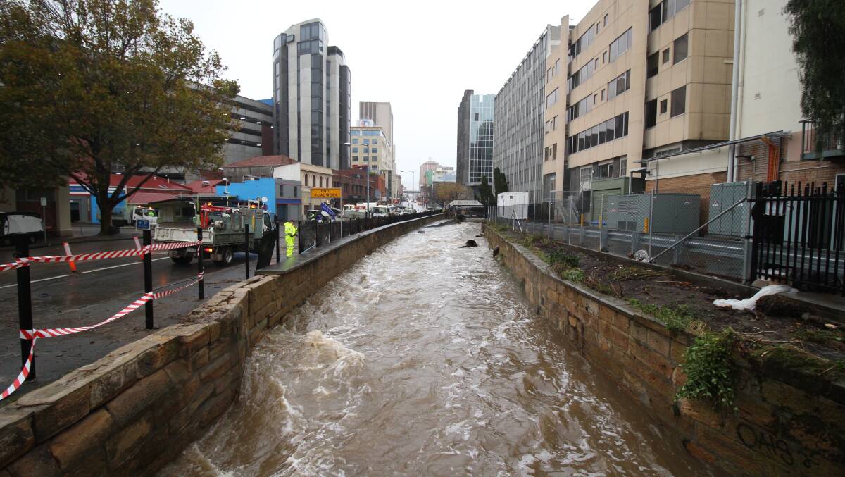 catastrophic: The swollen rivulet in central Hobart. Pictures: Monte Bovill.