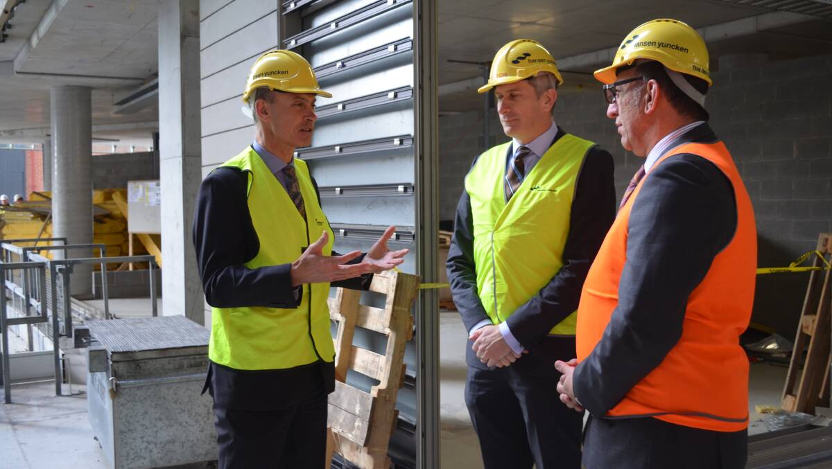 Construction Minister Guy Barnett talks building reforms with Michael Kerschbaum, of Master Builders Tasmania, and Rick Sassin, from the Housing Industry Association of Tasmania.