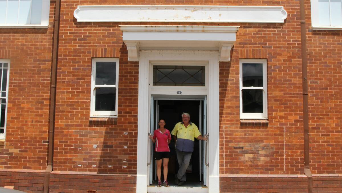 Samantha and Brian at the open door of the new Aussie Helpers headquarters, in the refurbished Bank of NSW in Charleville.